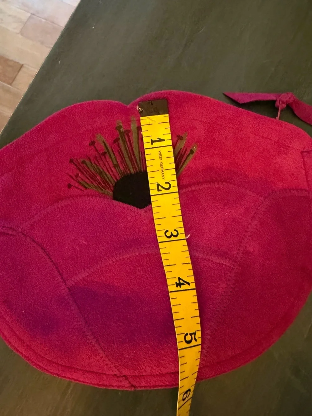 Maurice Keyloun New York magenta cosmetic pouch with zipper closure.